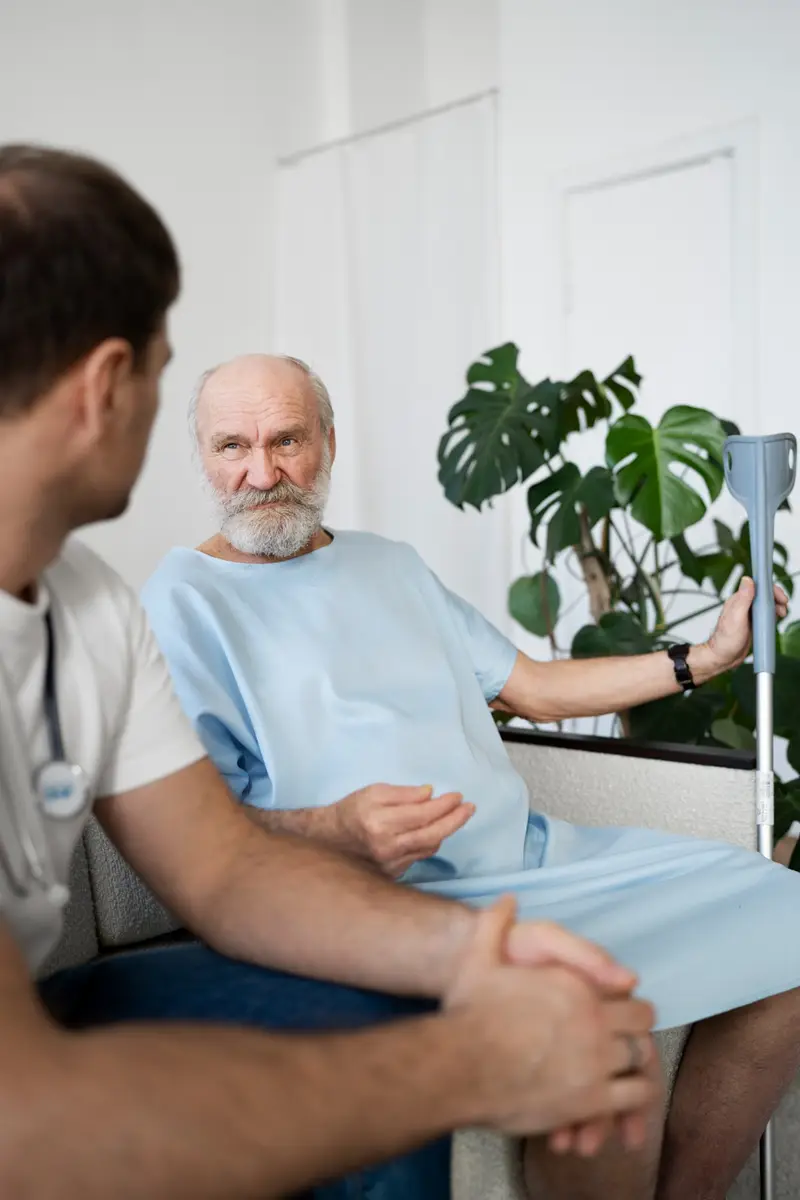 Healthcare provider visiting patient at home after hospital discharge providing transitional care management support reviewing medications and recovery plan